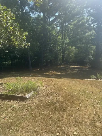 a backyard of a house with a yard and outdoor seating