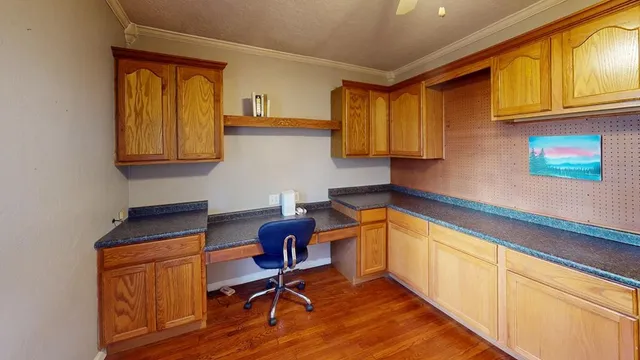 a kitchen with a sink cabinets and wooden floor