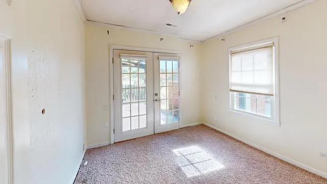 a view of an empty room with a window