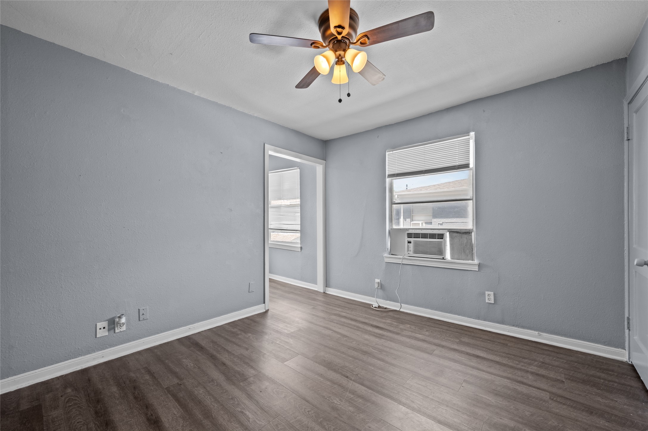 1919 McDuffie Street, Unit 2 Houston, TX 77019 - Photo 1 of 12 wooden floor in an empty room with a window