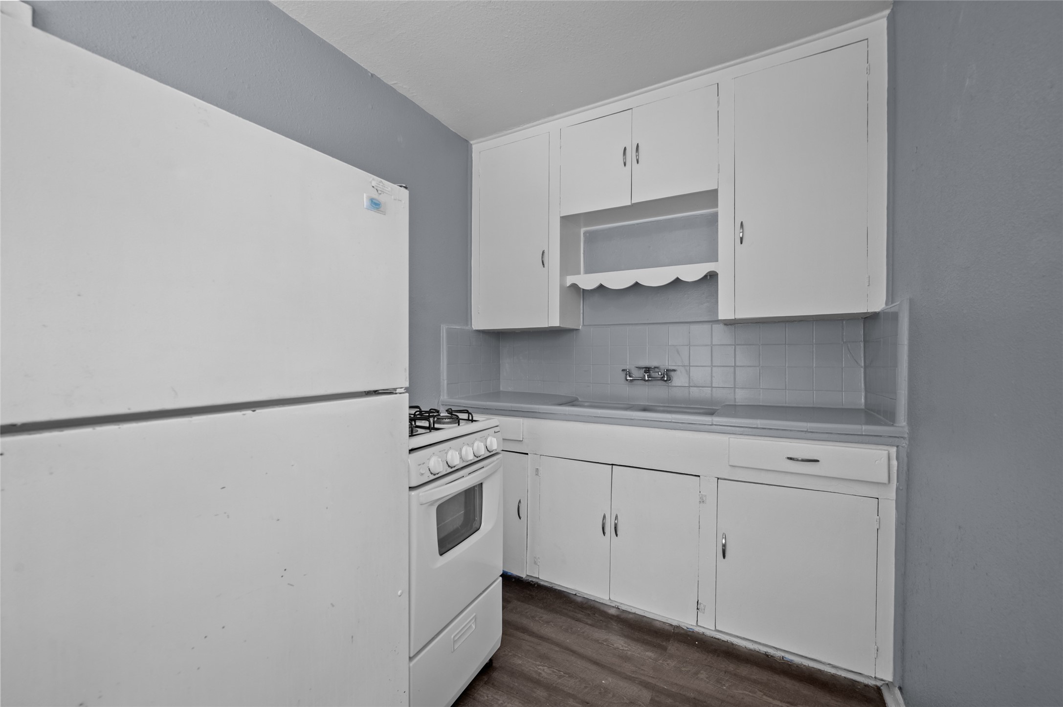 1919 McDuffie Street, Unit 2 Houston, TX 77019 - Photo 12 of 12 a white refrigerator freezer sitting inside of a kitchen