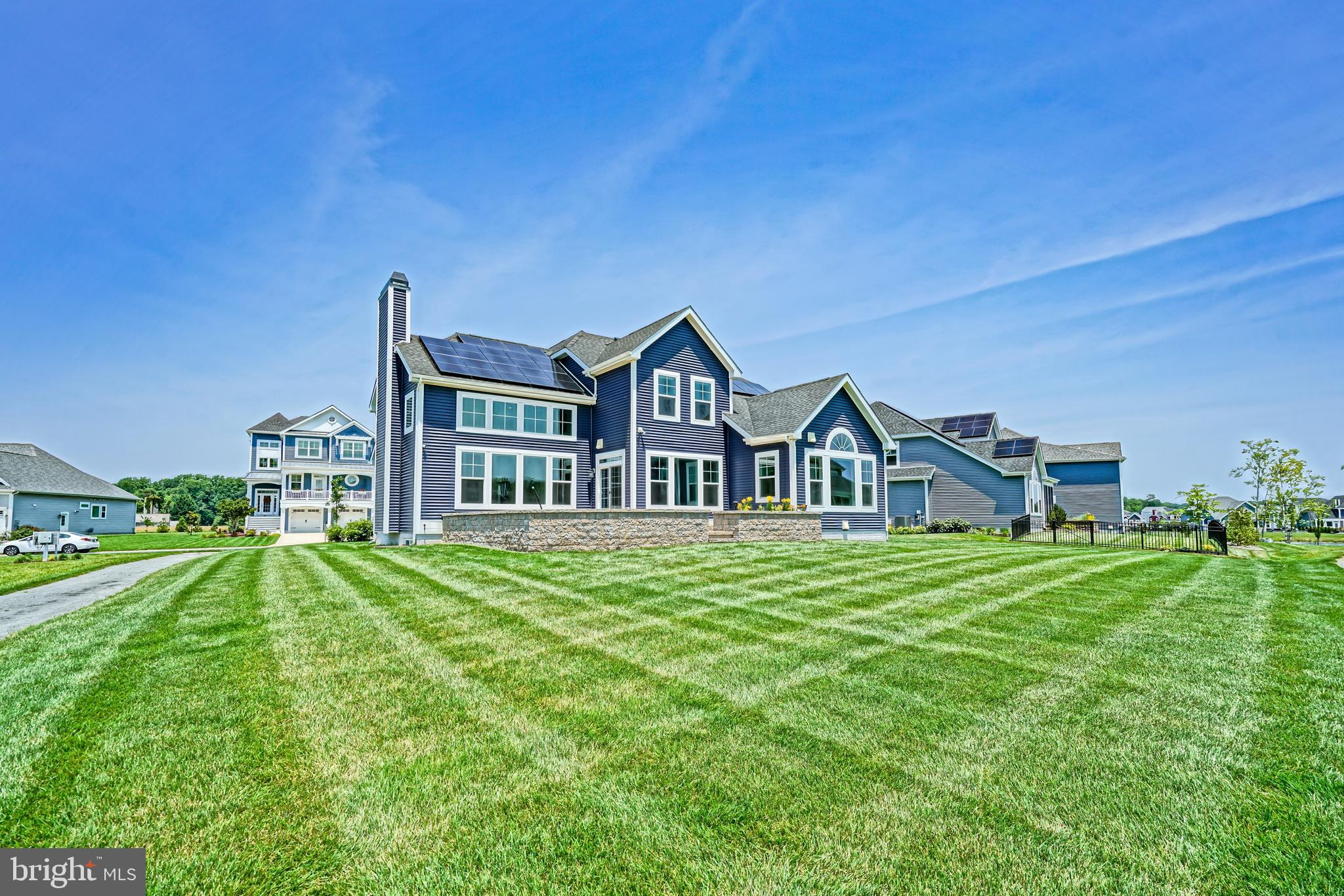 33557 Downing Circle Lewes, DE 19958 - Photo 75 of 89 a front view of a house with a yard table and chairs