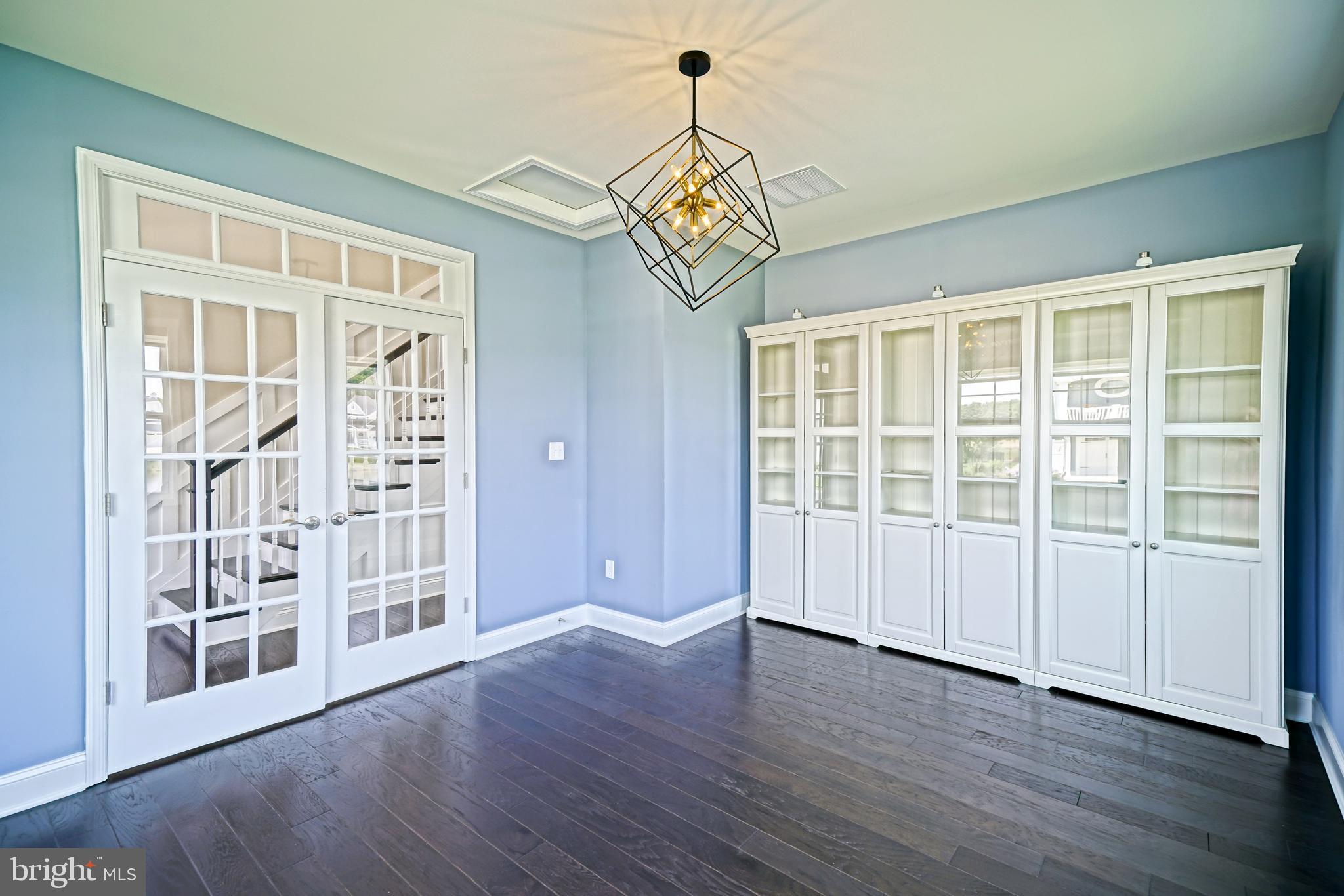 33557 Downing Circle Lewes, DE 19958 - Photo 8 of 89 a view of an empty room with wooden floor and a window
