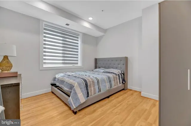 a bed sitting in a bedroom next to a window