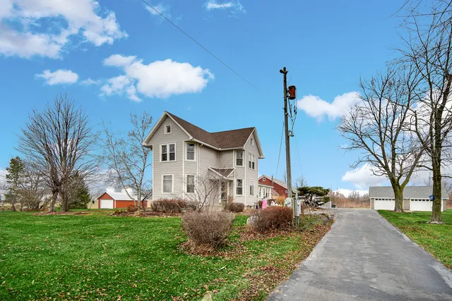 a house with green field in front of it