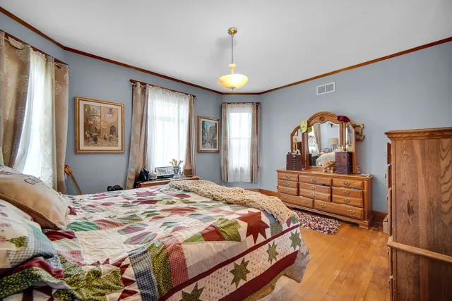 a bedroom with a bed and a chandelier