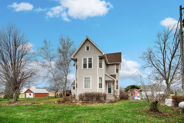 a view of house with yard and green space