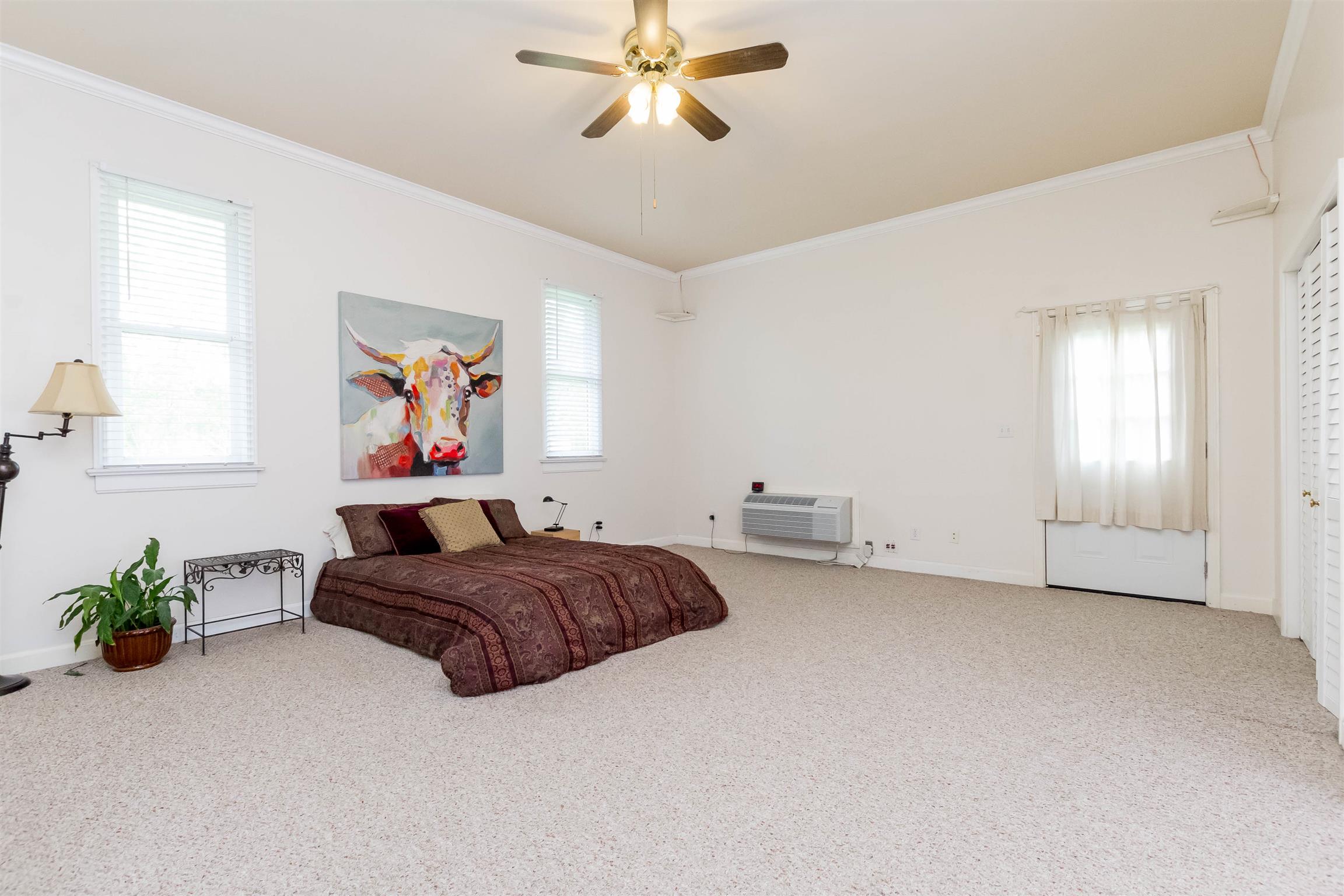 9723 Concord Road Brentwood, TN 37027 - Photo 17 of 30 a bed room with a bed and a chandelier