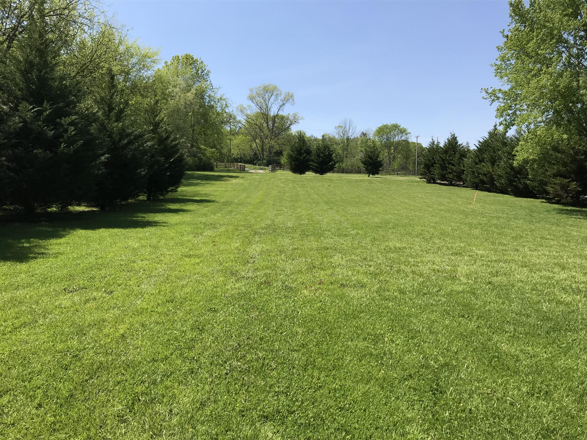 9723 Concord Road Brentwood, TN 37027 - Photo 2 of 30 a view of a green field with wooden fence