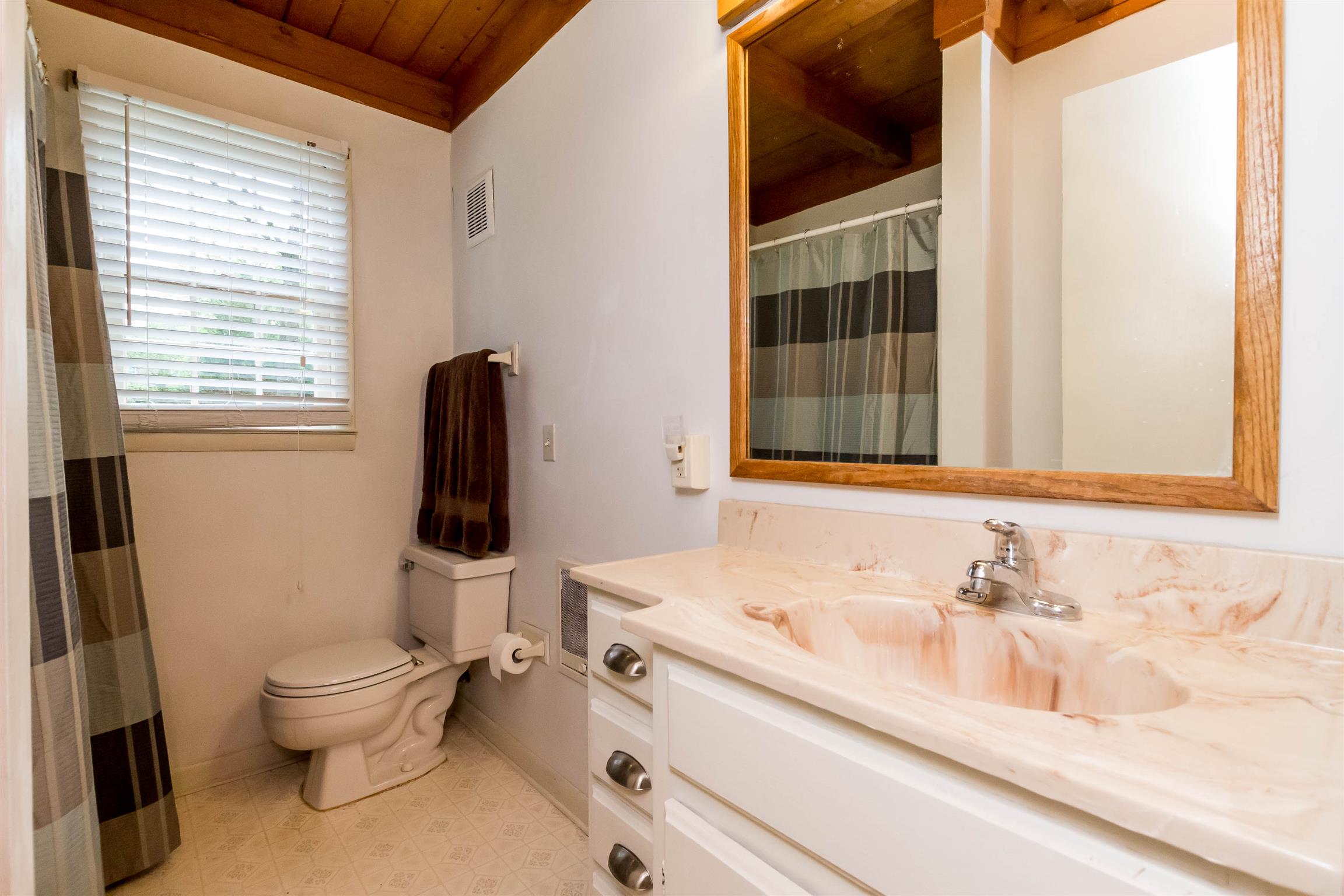 9723 Concord Road Brentwood, TN 37027 - Photo 23 of 30 a bathroom with a granite countertop sink toilet and shower