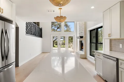 a view of a refrigerator in kitchen and window