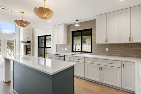 a large kitchen with cabinets and stainless steel appliances
