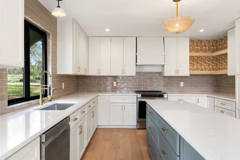 a kitchen with a sink cabinets and window