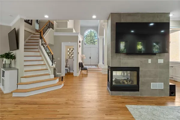 a living room with furniture potted plant and a large window