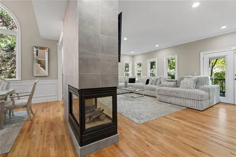 a kitchen with stainless steel appliances a table chairs refrigerator and sink