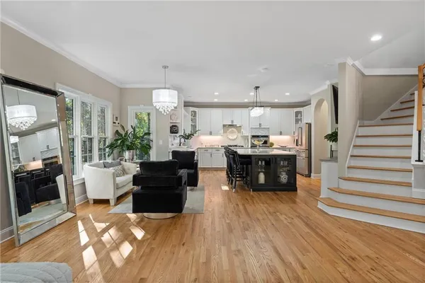 a kitchen with kitchen island granite countertop a sink stainless steel appliances and cabinets