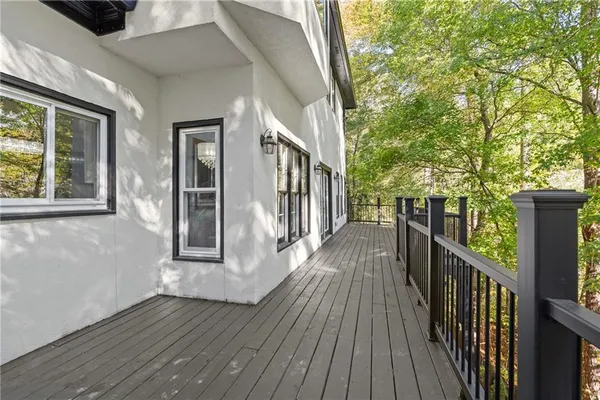 a spacious bedroom with a large bed and a chandelier