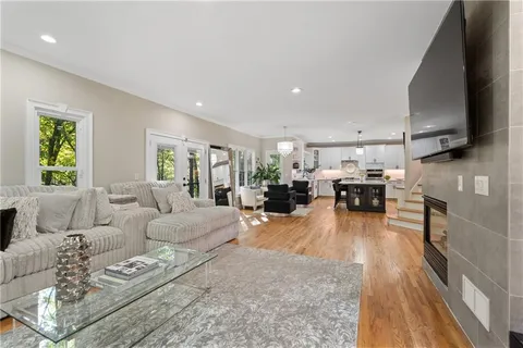 a spacious bedroom with a bed and a television