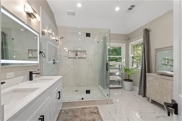 a en suite bathroom with a sink and mirror