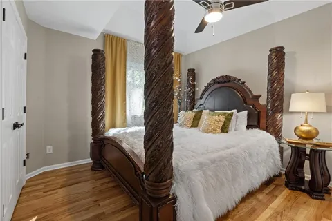 a bedroom with a bed and a chandelier