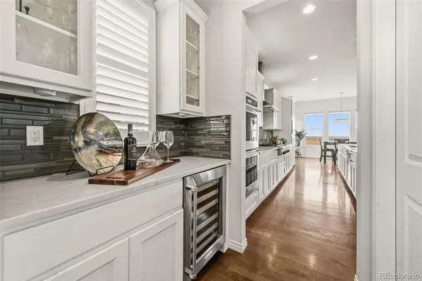 a kitchen with a refrigerator and a sink