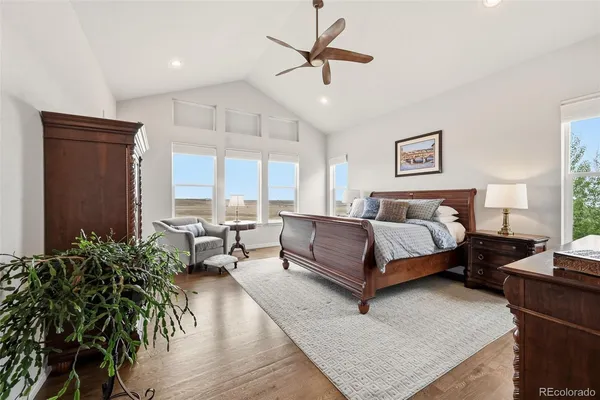 a bedroom with a large bed and a potted plant