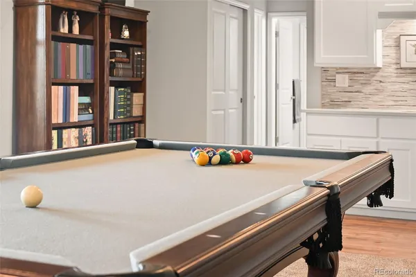 a room with a table and a book shelf