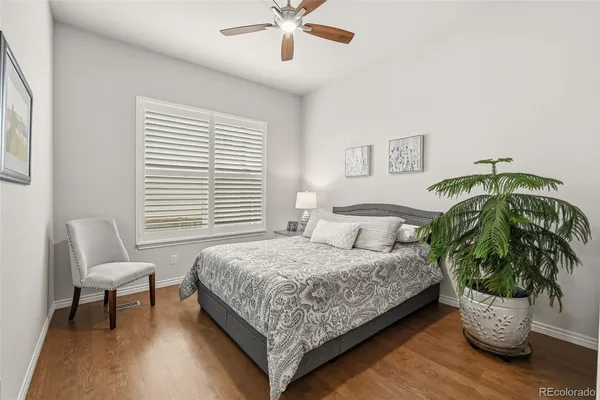 a bedroom with a bed and a potted plant