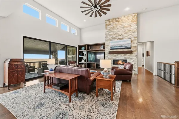 a living room with furniture a rug and a fireplace