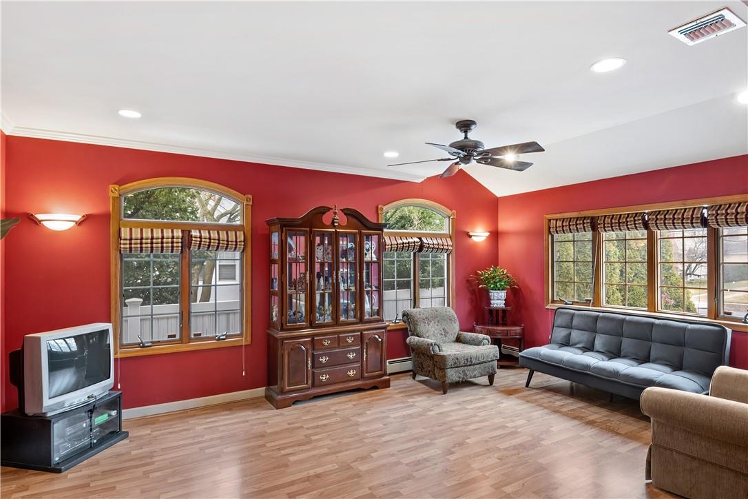 a living room with furniture a floor to ceiling window and a flat screen tv