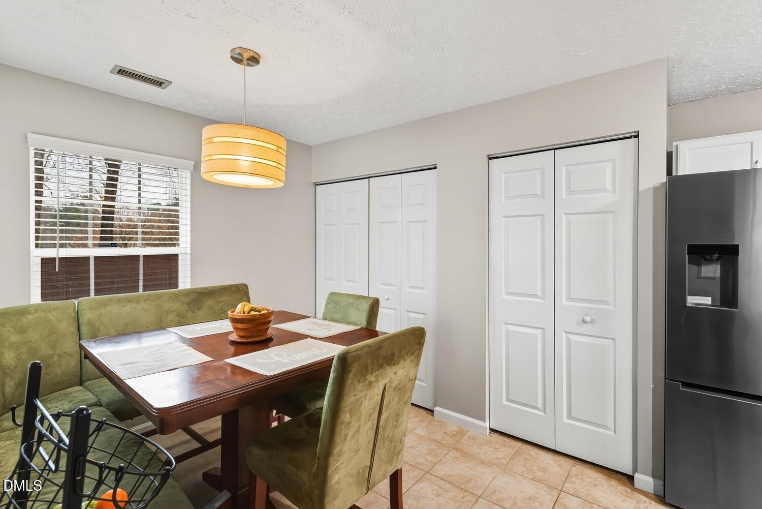 6900 Glenroy Court Raleigh, NC 27616 - Photo 11 of 30 a view of a dining room with a table and chairs