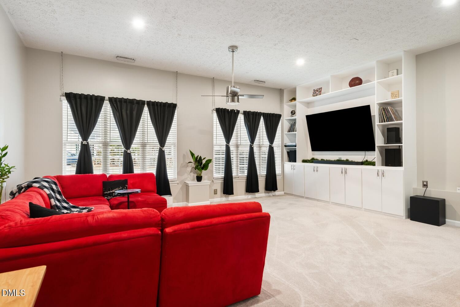 6900 Glenroy Court Raleigh, NC 27616 - Photo 13 of 30 a living room with furniture and a flat screen tv