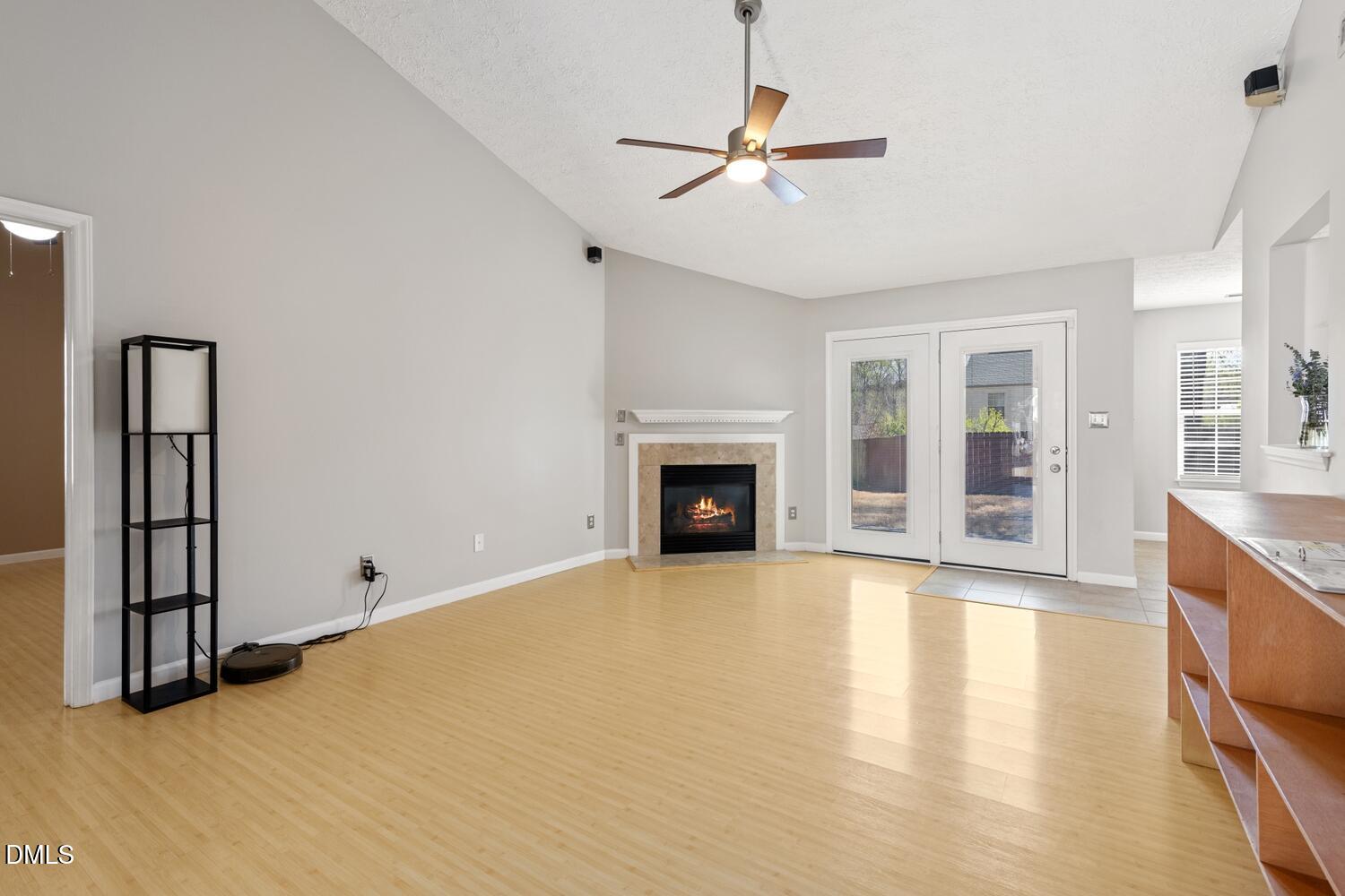 6900 Glenroy Court Raleigh, NC 27616 - Photo 3 of 30 a view of an empty room with a fireplace and a window
