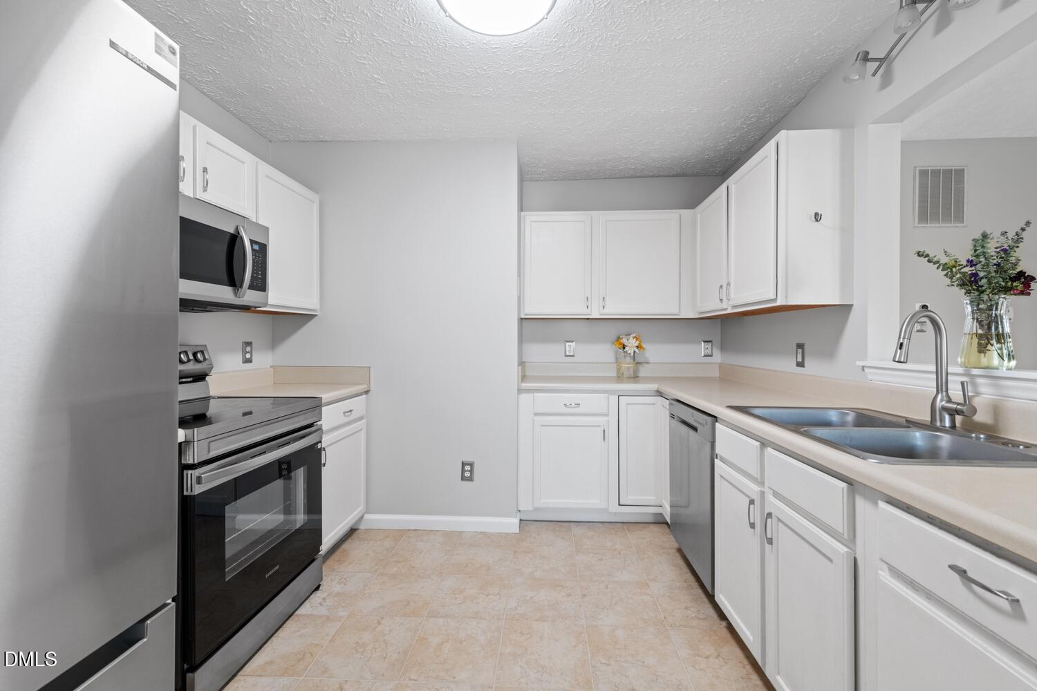 6900 Glenroy Court Raleigh, NC 27616 - Photo 4 of 30 a kitchen with cabinets stainless steel appliances and a sink