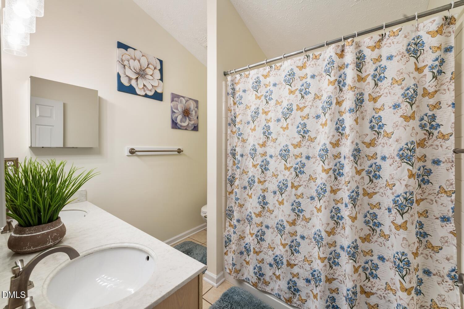 6900 Glenroy Court Raleigh, NC 27616 - Photo 7 of 30 a bathroom with a sink toilet and shower