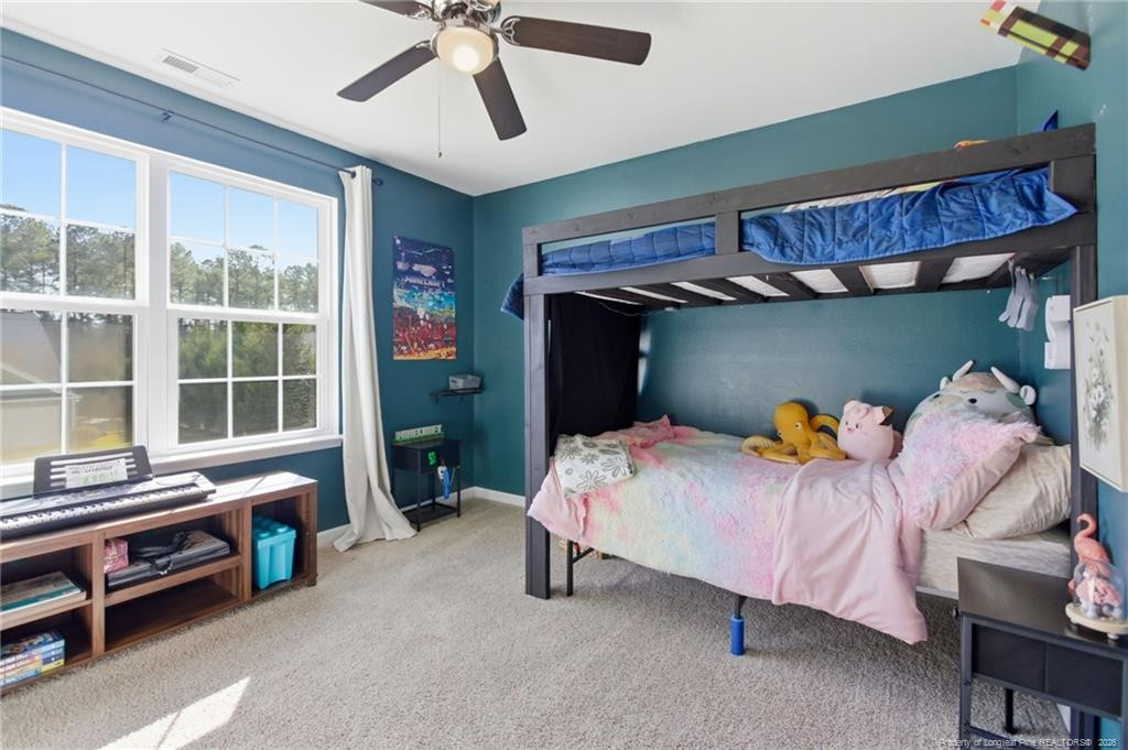 334 Crane Way Bunnlevel, NC 28323 - Photo 26 of 45 a bedroom with furniture and a chandelier