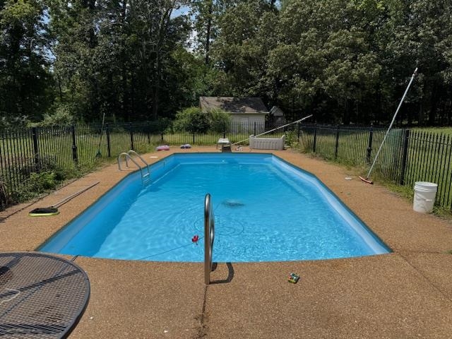 110 Falcon Cove Middleton, TN 38052 - Photo 6 of 20 a view of a swimming pool with a patio and a yard