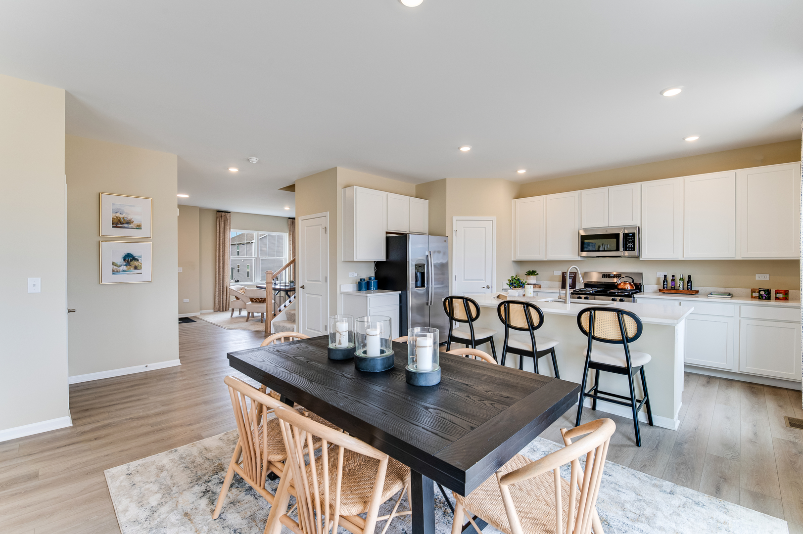 932 Juniper Drive Sycamore, IL 60178 - Photo 5 of 24 a kitchen with stainless steel appliances granite countertop a table chairs and a refrigerator