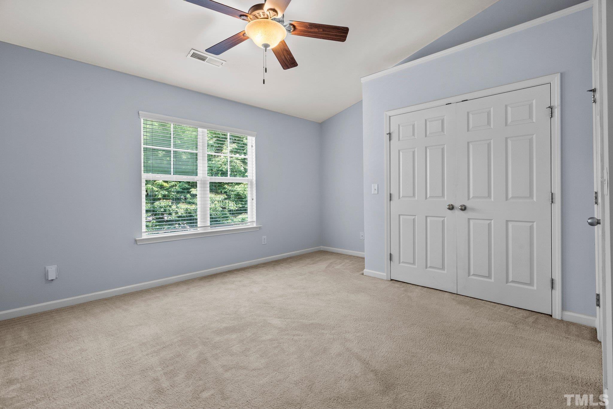 3012 Berkeley Springs Place Raleigh, NC 27616 - Photo 11 of 22 an empty room with windows and fan