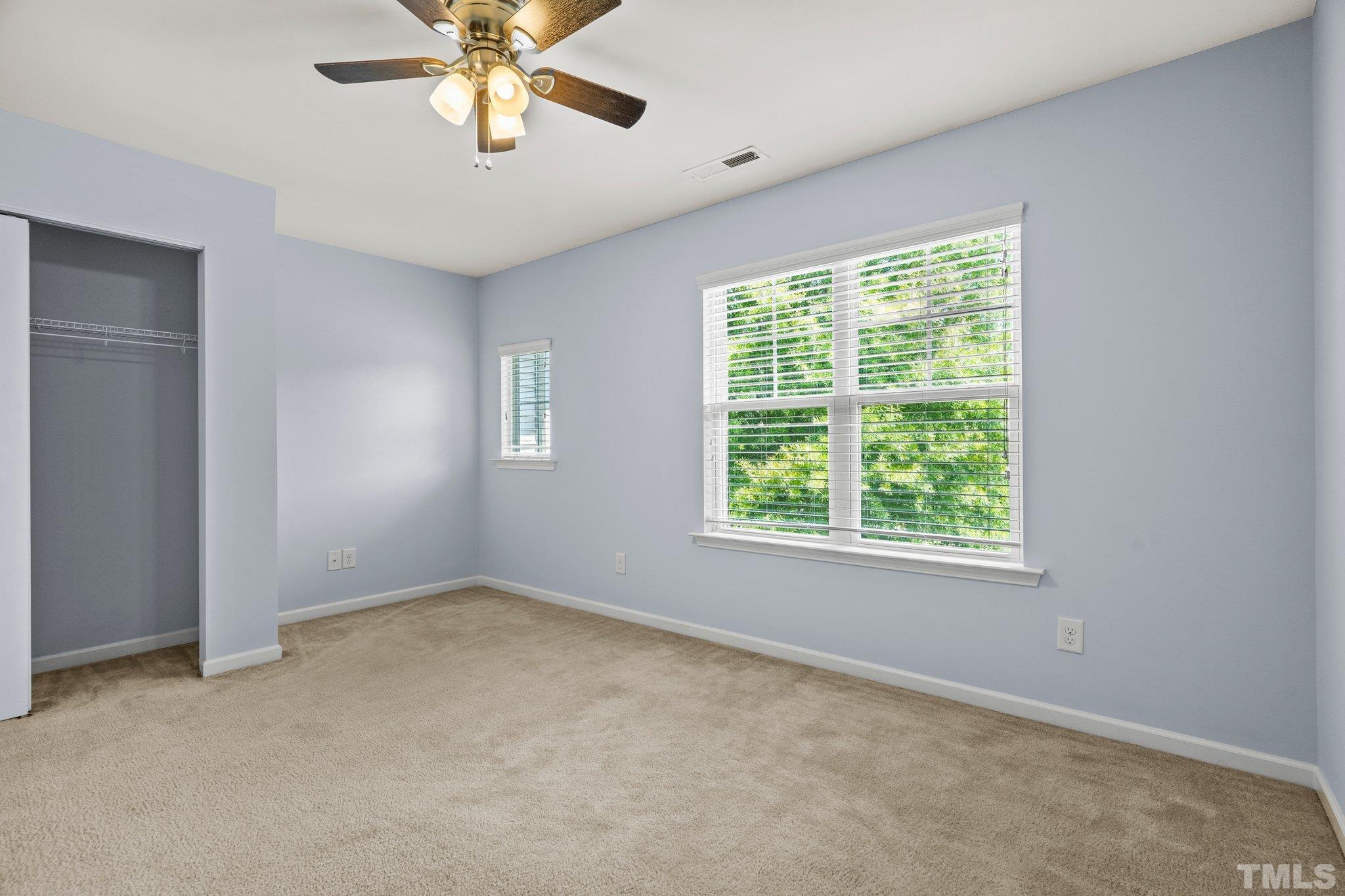 3012 Berkeley Springs Place Raleigh, NC 27616 - Photo 14 of 22 an empty room with a window and a fan