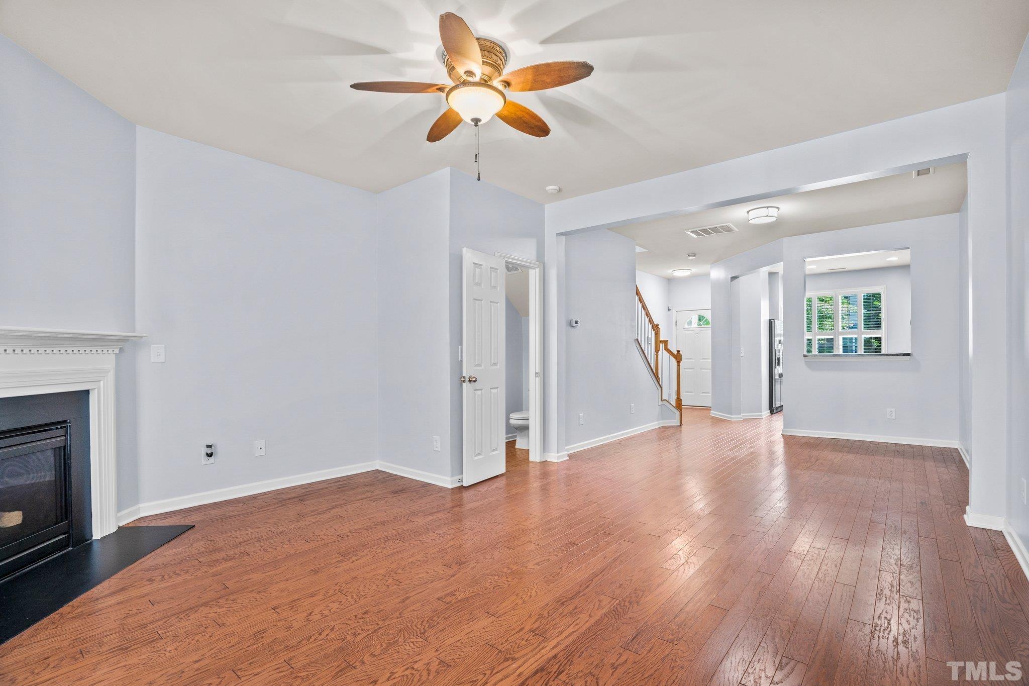 3012 Berkeley Springs Place Raleigh, NC 27616 - Photo 5 of 22 a view of empty room with wooden floor and a fireplace