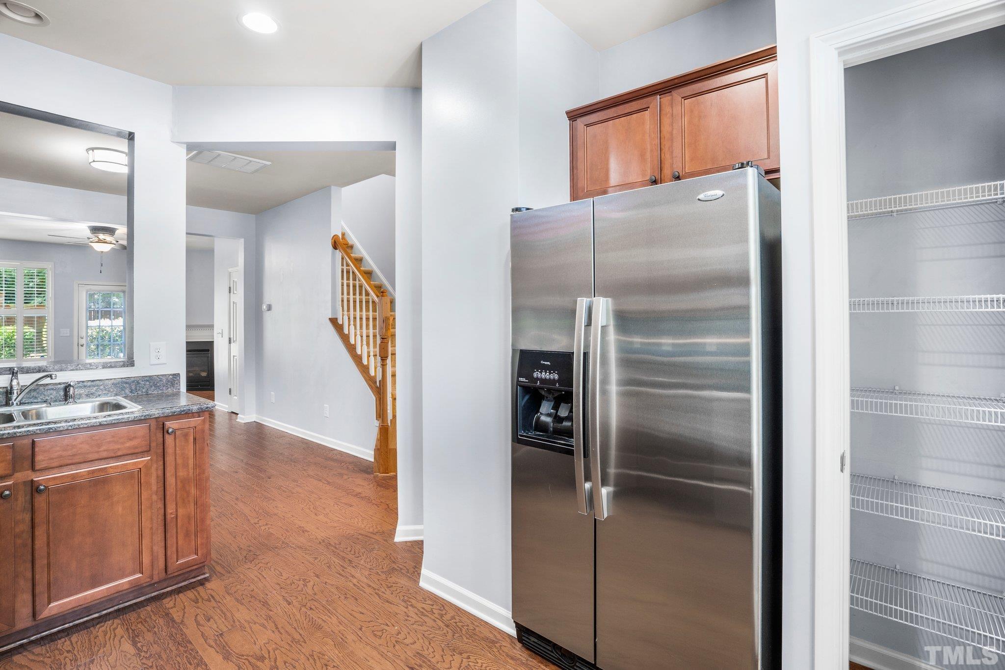 3012 Berkeley Springs Place Raleigh, NC 27616 - Photo 9 of 22 a kitchen with granite countertop a refrigerator and a sink