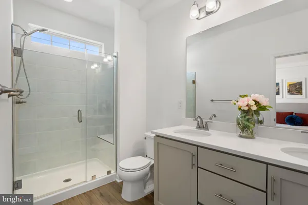 a bathroom with a sink a toilet and shower
