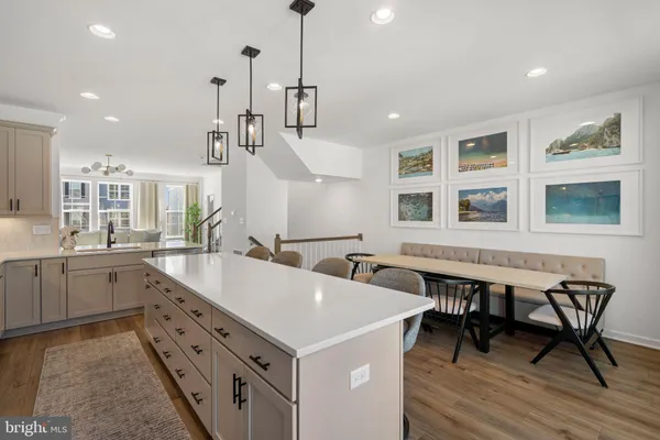 a large white kitchen with a table and chairs