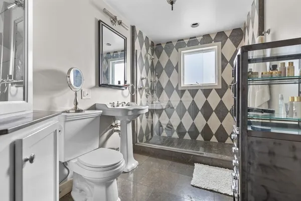 a bathroom with a sink toilet and shower