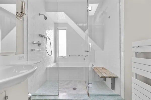 a bathroom with a bathtub and a shower