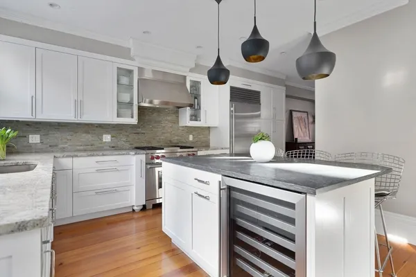a kitchen with a counter space cabinets and wooden floor