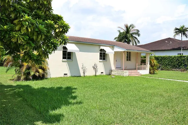 a front view of house with yard and green space