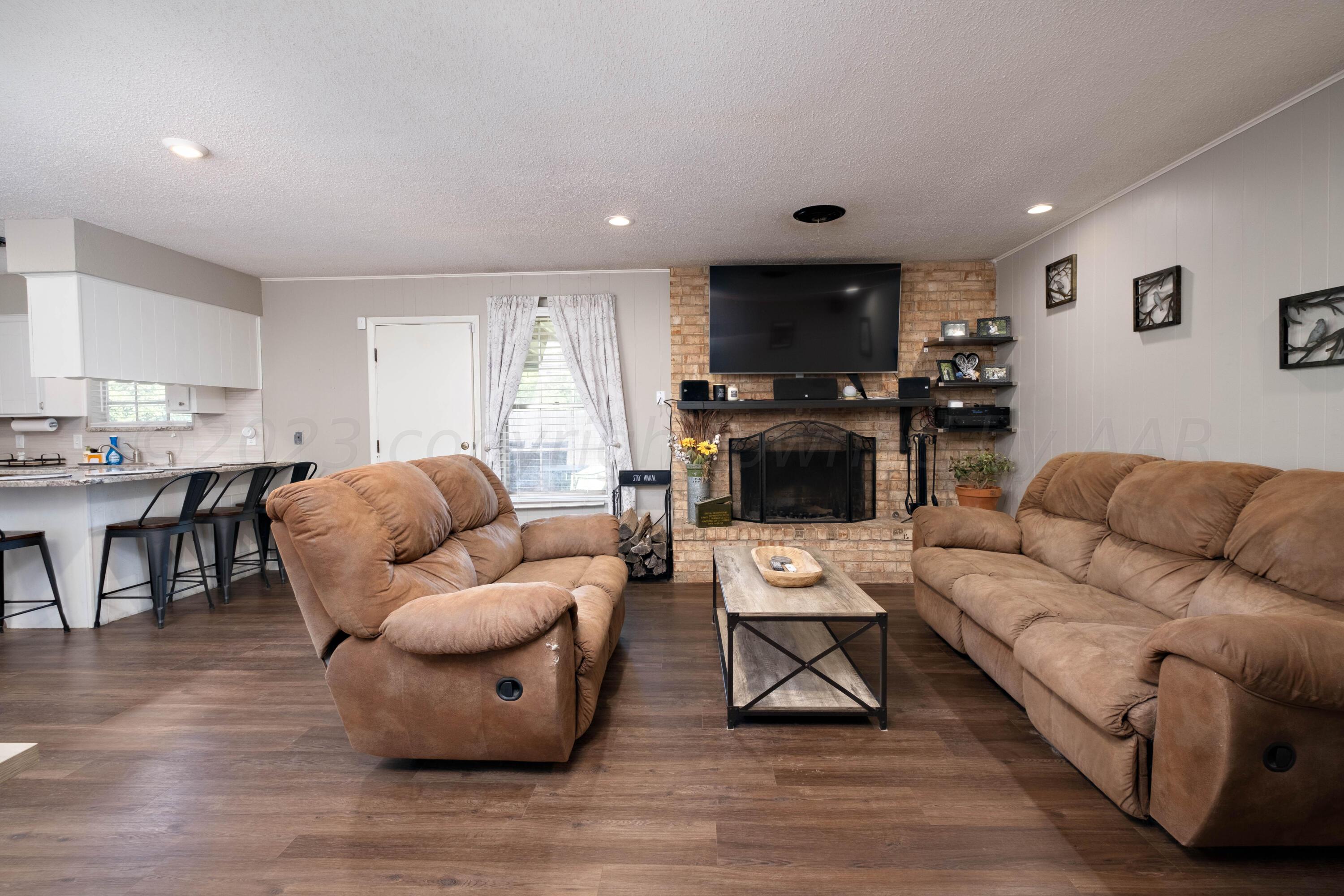 4813 South Rusk Street Amarillo, TX 79110 - Photo 2 of 23 a living room with furniture and a wooden floor