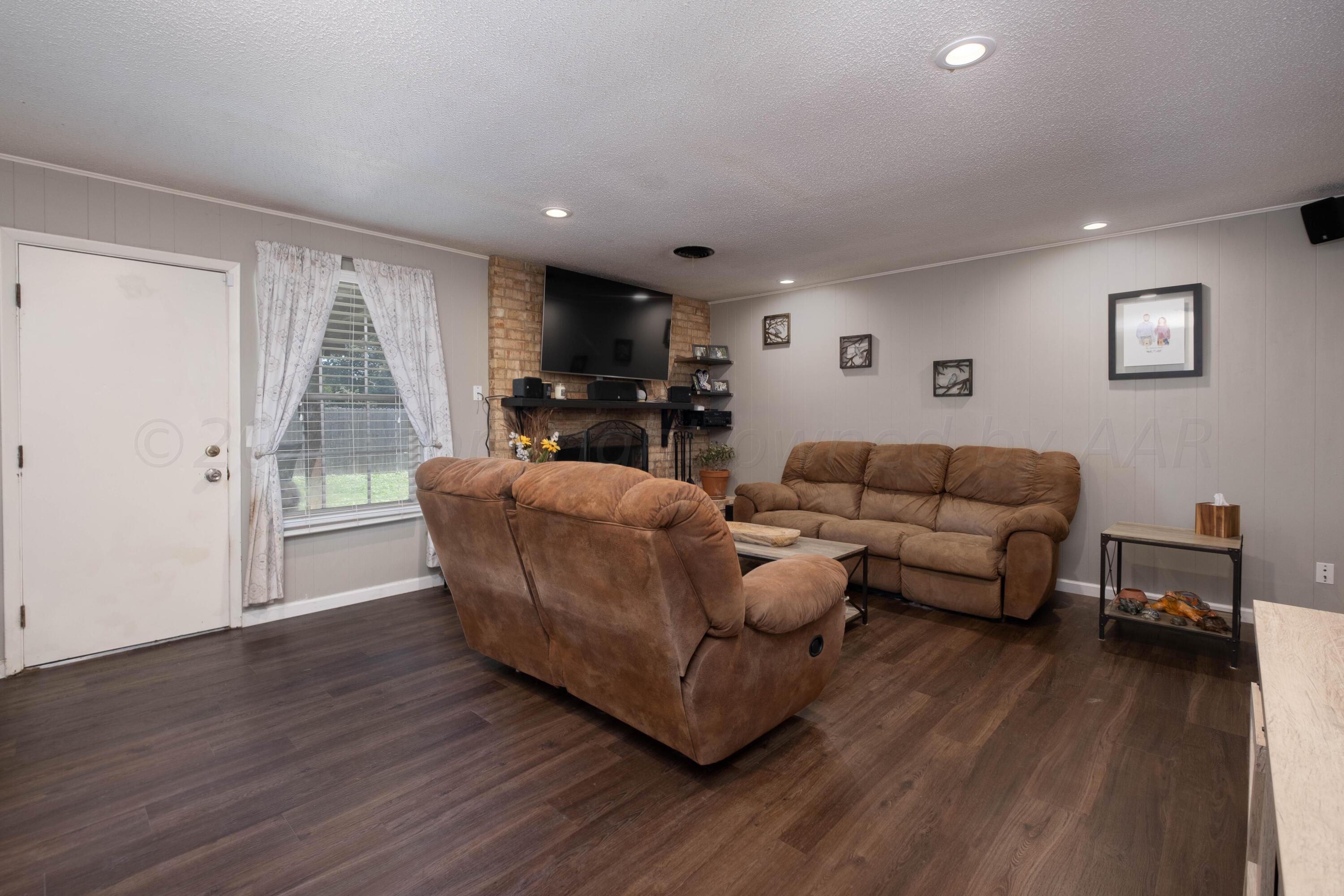 4813 South Rusk Street Amarillo, TX 79110 - Photo 3 of 23 a living room with furniture and a wooden floor